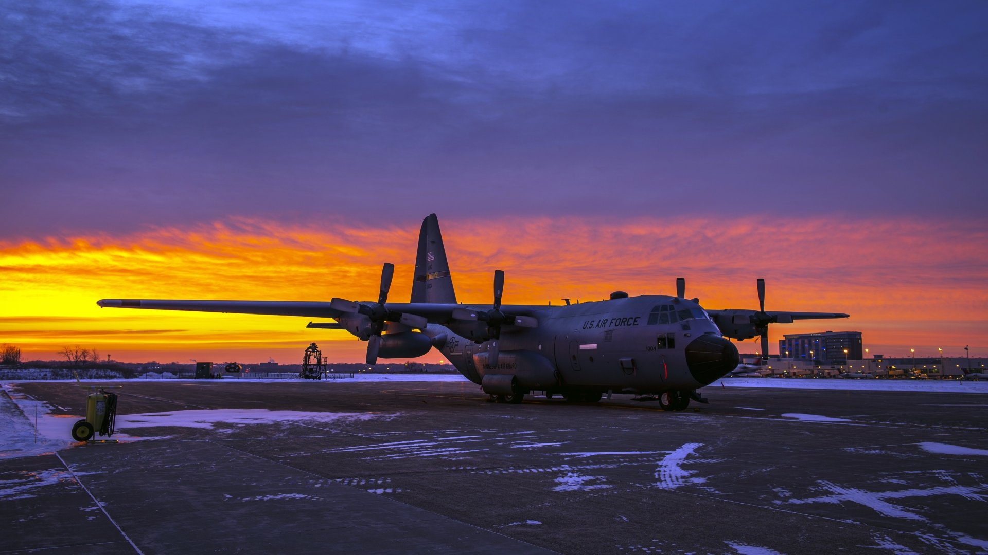 Military aircraft on the tarmac at sunset
